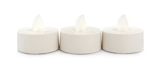 Photo of Decorative flameless LED candles on white background
