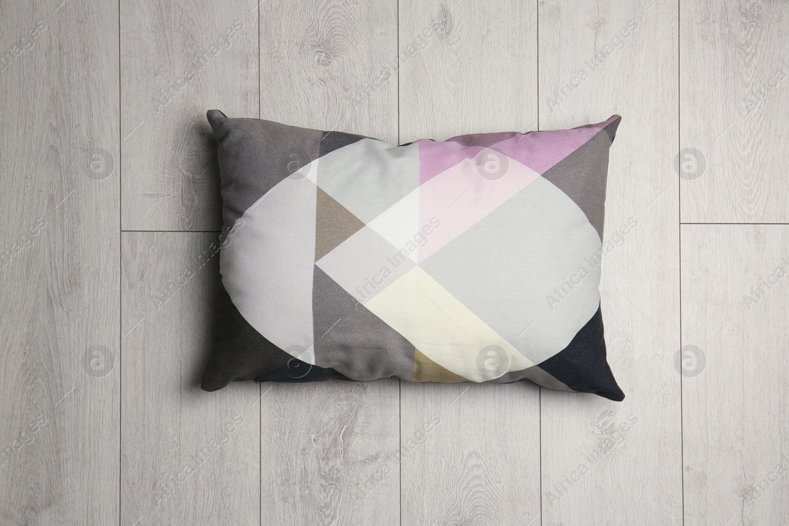 Photo of Soft decorative pillow on wooden background, top view