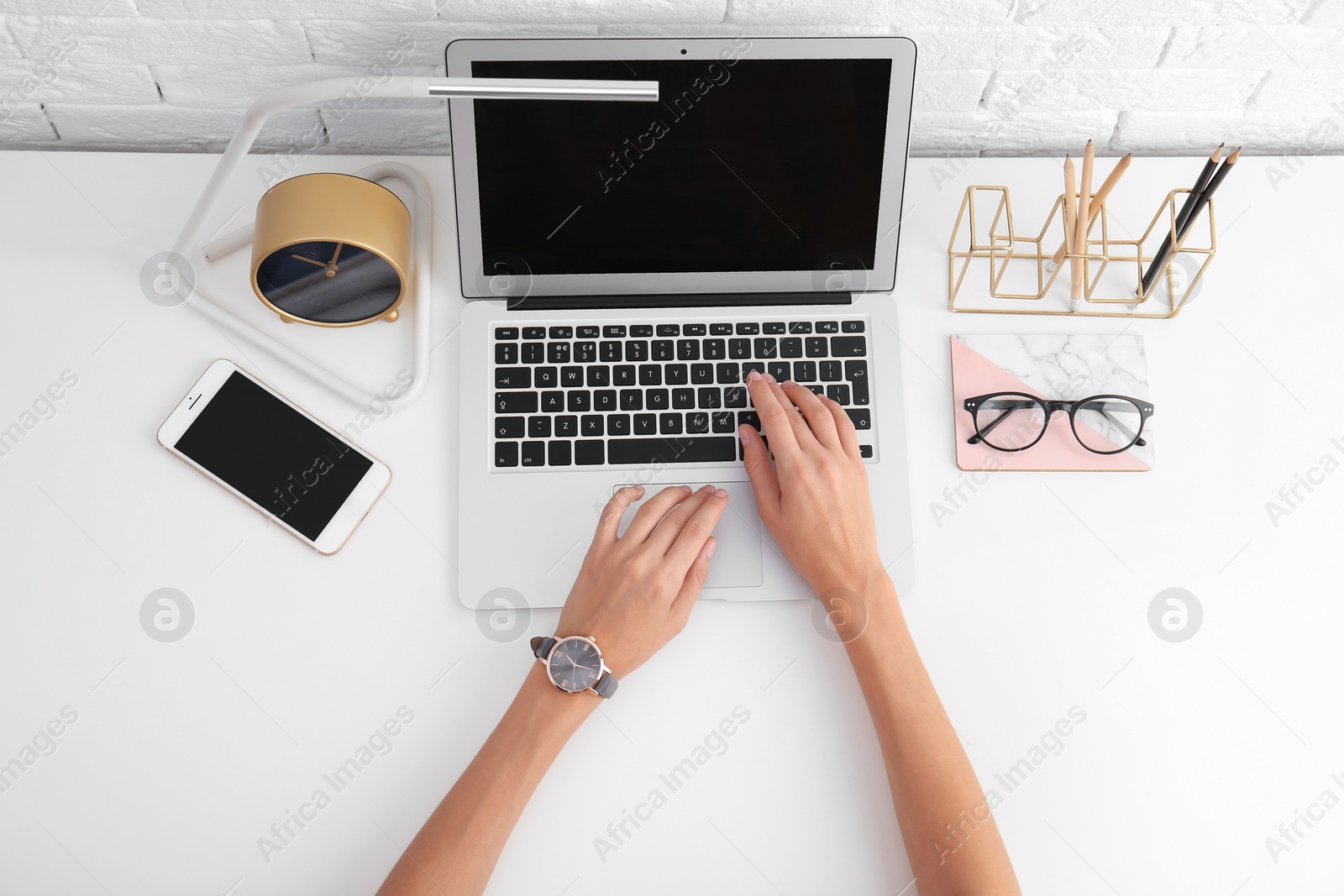 Photo of Woman using with laptop at table, top view. Mockup for design