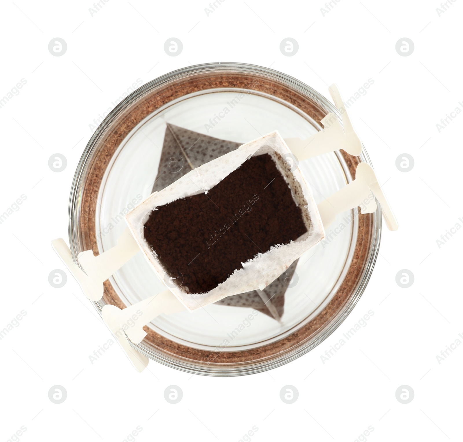 Photo of Glass cup with drip coffee bag isolated on white, top view