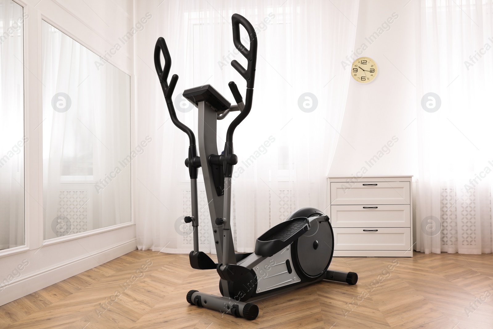 Photo of Elliptical machine cross trainer near mirror indoors