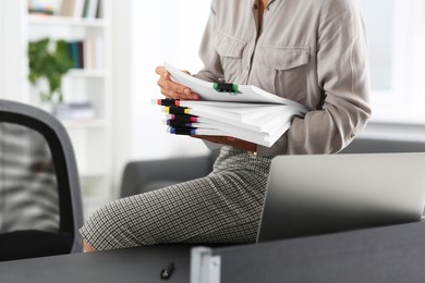Photo of Businesswoman with documents on grey table in office, closeup