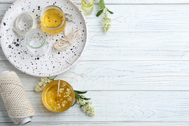 Photo of Flat lay composition with candle on wooden background. Space for text