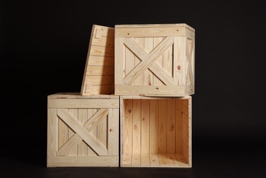 Photo of Group of wooden crates on black background