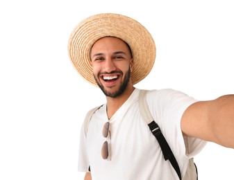 Photo of Smiling young man in straw hat taking selfie on white background