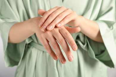 Photo of Woman applying luxury cosmetic cream onto hand, closeup
