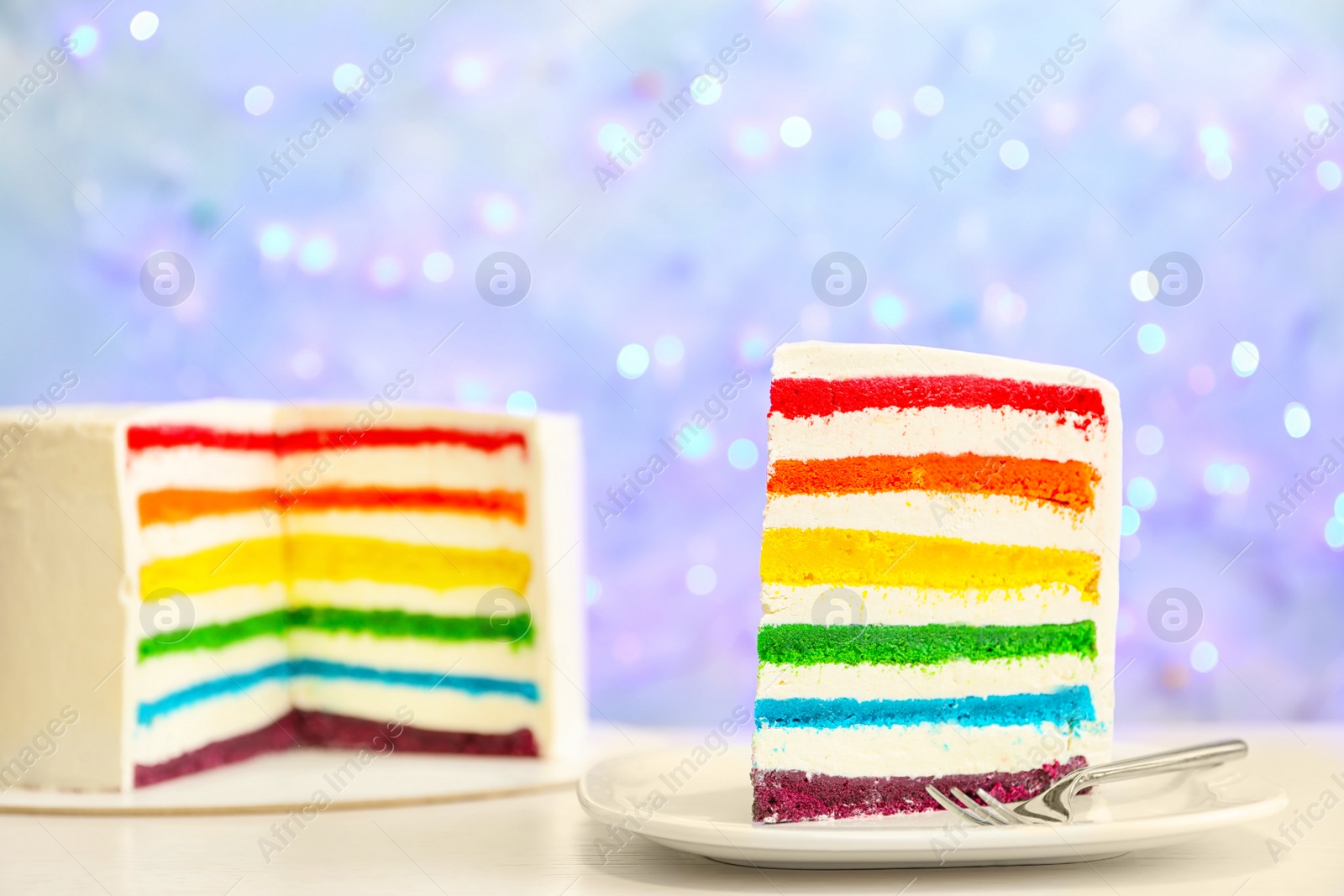 Photo of Delicious rainbow cake for party on table