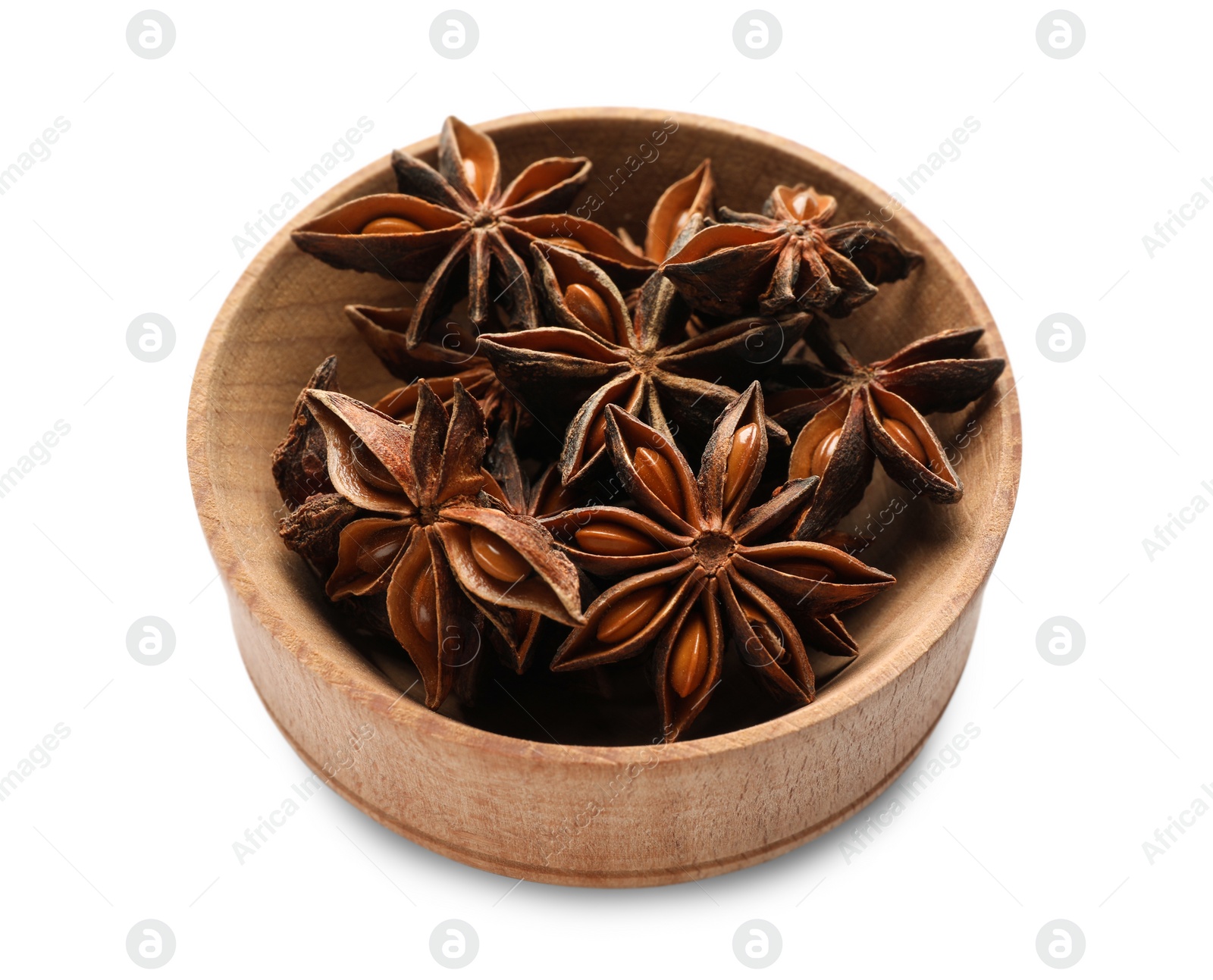 Photo of Aromatic anise stars in wooden bowl isolated on white