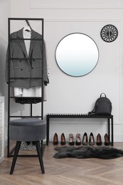Photo of Dressing room with stylish clothes and shoes. Elegant interior design