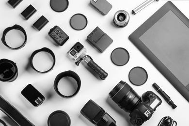 Composition with photographer's equipment and accessories on white background, top view