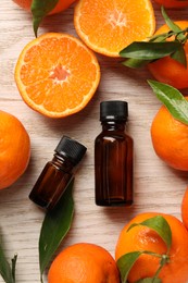 Flat lay composition with tangerine essential oil on wooden table