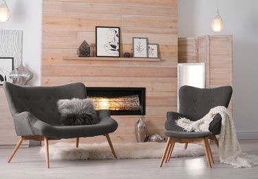 Photo of Cozy living room interior with comfortable furniture and decorative fireplace