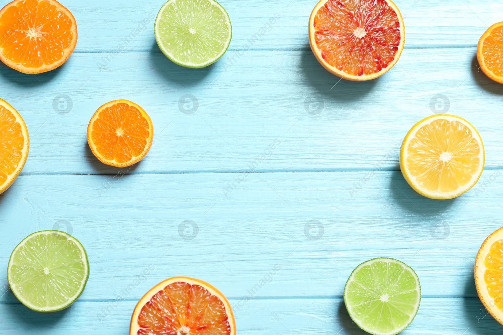 Photo of Flat lay composition with different citrus fruits and space for text on wooden background