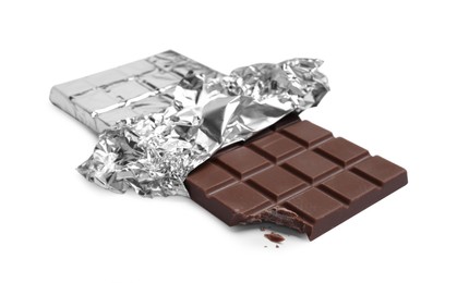 Photo of Bitten milk chocolate bar wrapped in foil isolated on white