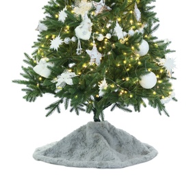 Decorated Christmas tree with faux fur skirt isolated on white