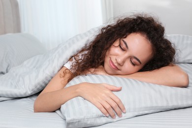 Photo of Beautiful African American woman sleeping in bed at home