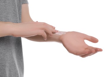 Photo of Man applying ointment onto his arm on white background, closeup