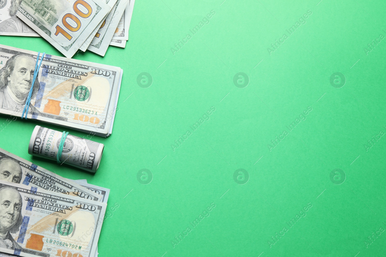 Photo of Many dollar banknotes on green background, flat lay. Space for text