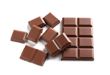 Pieces of tasty milk chocolate on white background