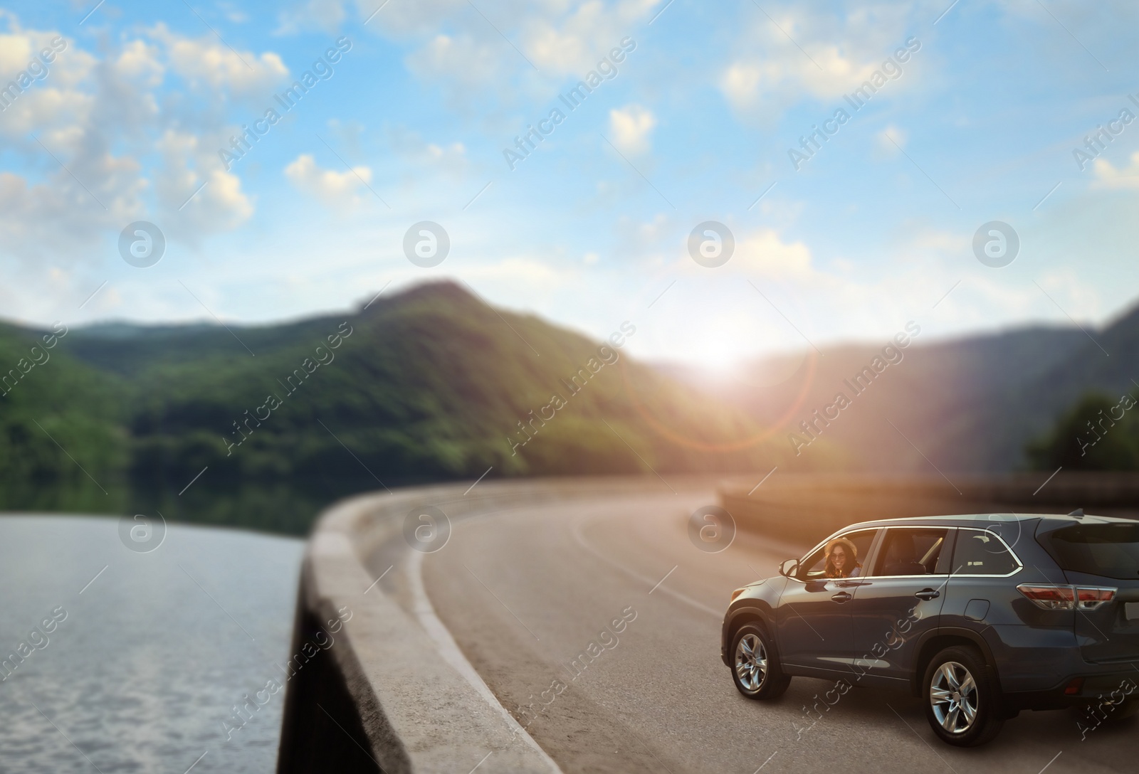 Image of Road trip. Young beautiful woman in car on asphalt highway, space for text  