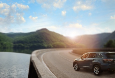 Image of Road trip. Young beautiful woman in car on asphalt highway, space for text  