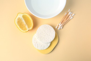 Lemon face wash. Fresh citrus fruits and personal care products on beige background, flat lay