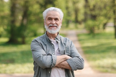 Photo of Portrait of happy grandpa in spring park