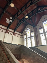 Photo of Lyceum hall with beautiful stained glass windows and modern lamps