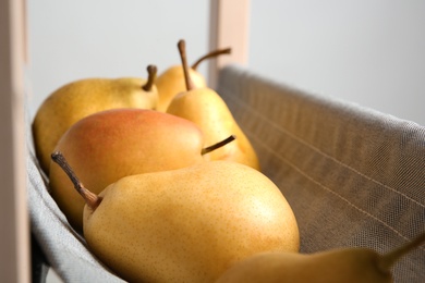 Ripe yellow pears on fabric shelf, closeup