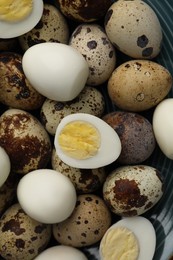 Photo of Peeled and unpeeled hard boiled quail eggs in plate, top view