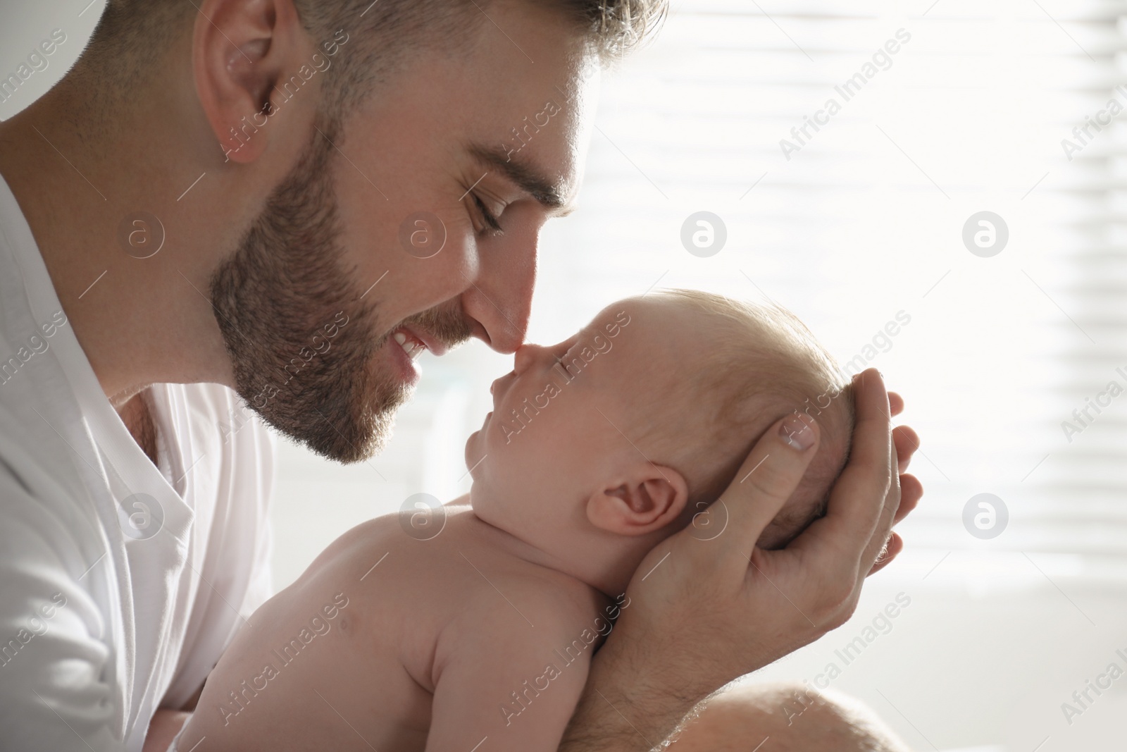 Photo of Father with his newborn son at home, closeup