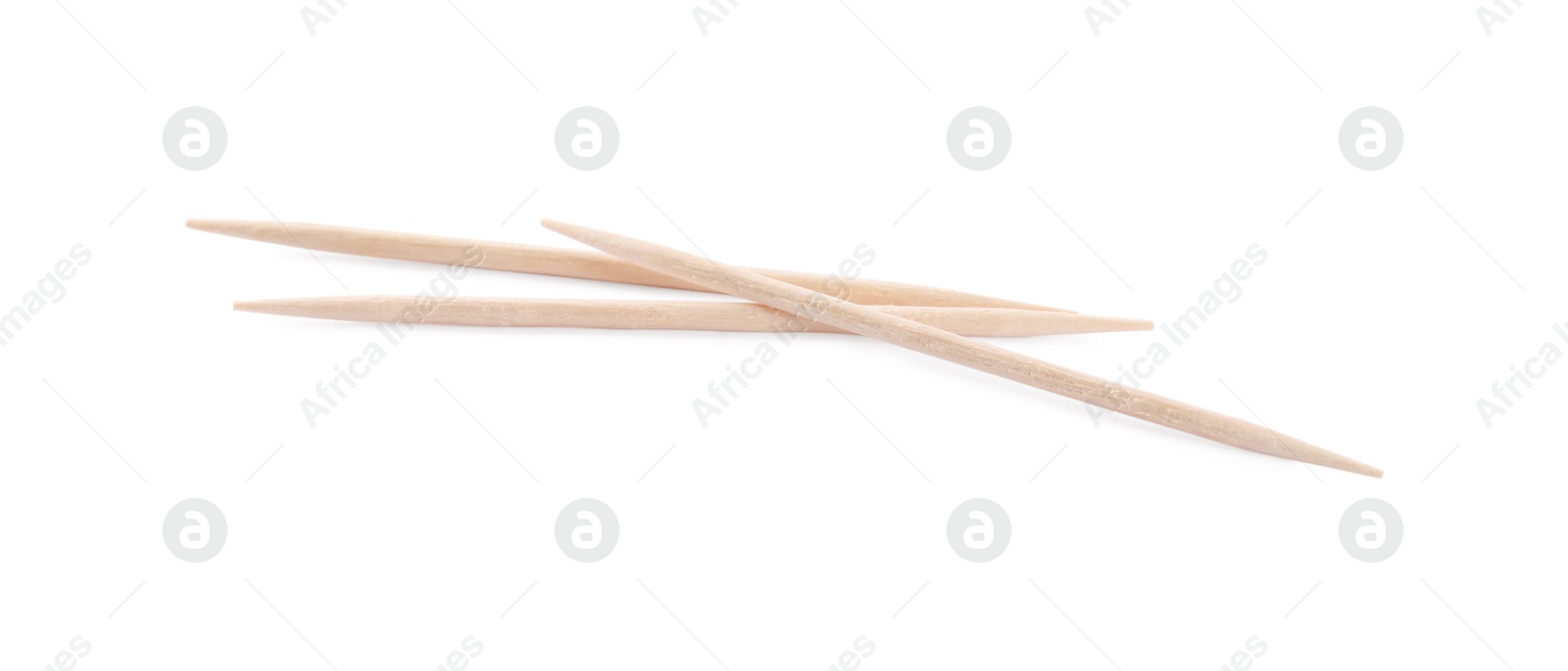 Photo of Three disposable wooden toothpicks on white background