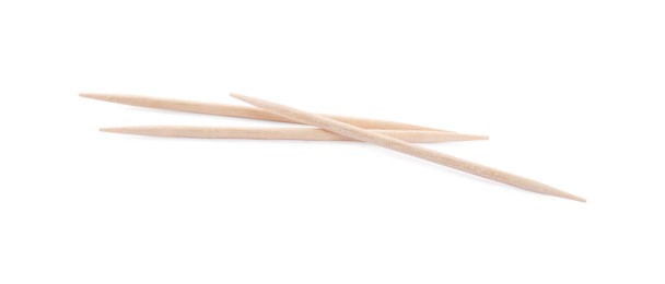 Three disposable wooden toothpicks on white background