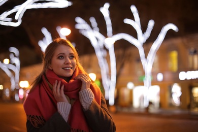 Photo of Beautiful young woman spending time in city at night