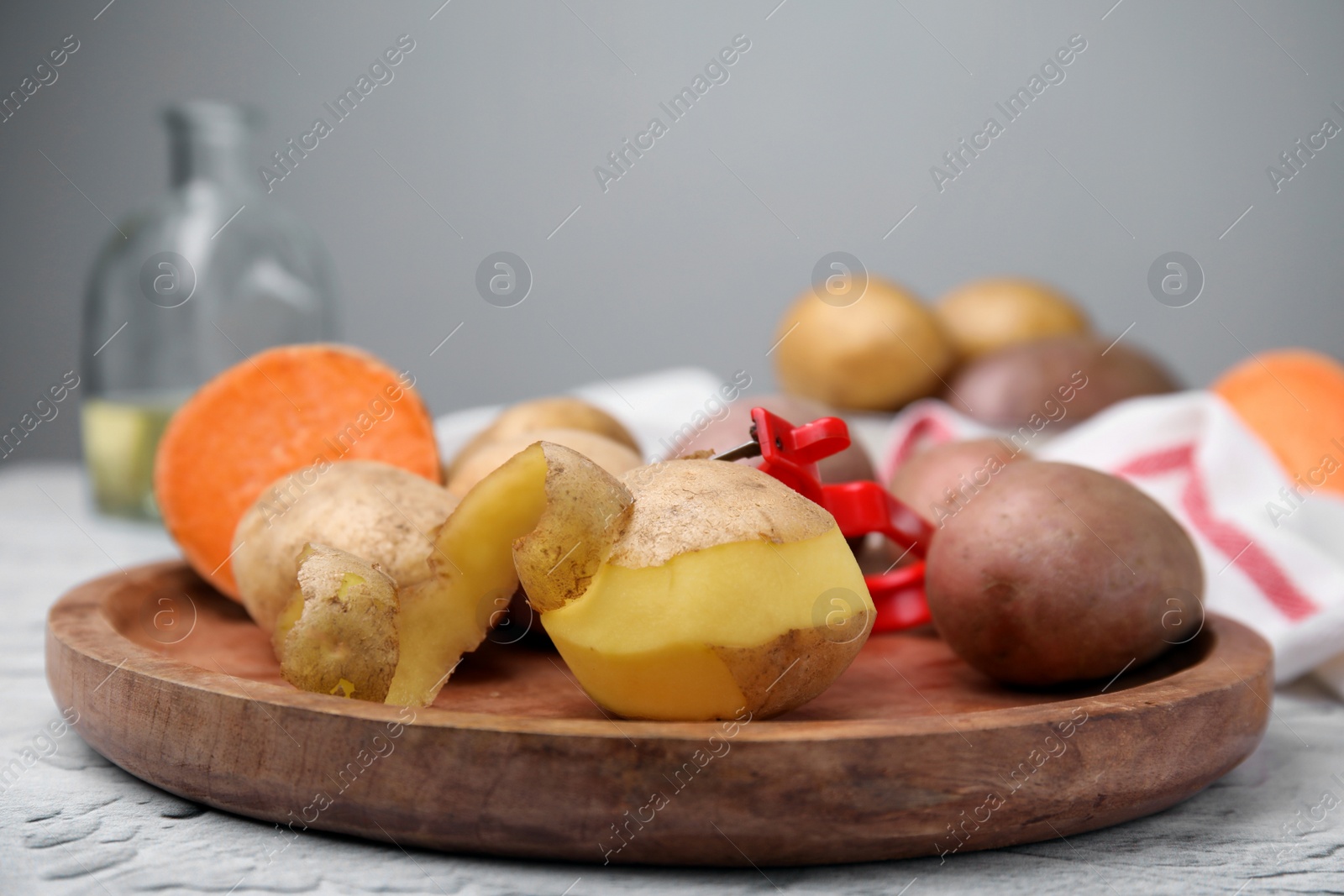 Photo of Different types of fresh potatoes on white textured table, closeup