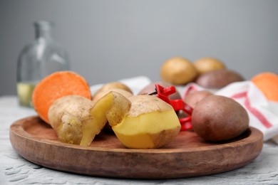 Different types of fresh potatoes on white textured table, closeup