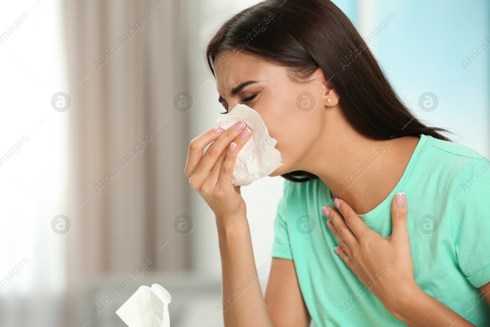 Photo of Young woman suffering from allergy at home