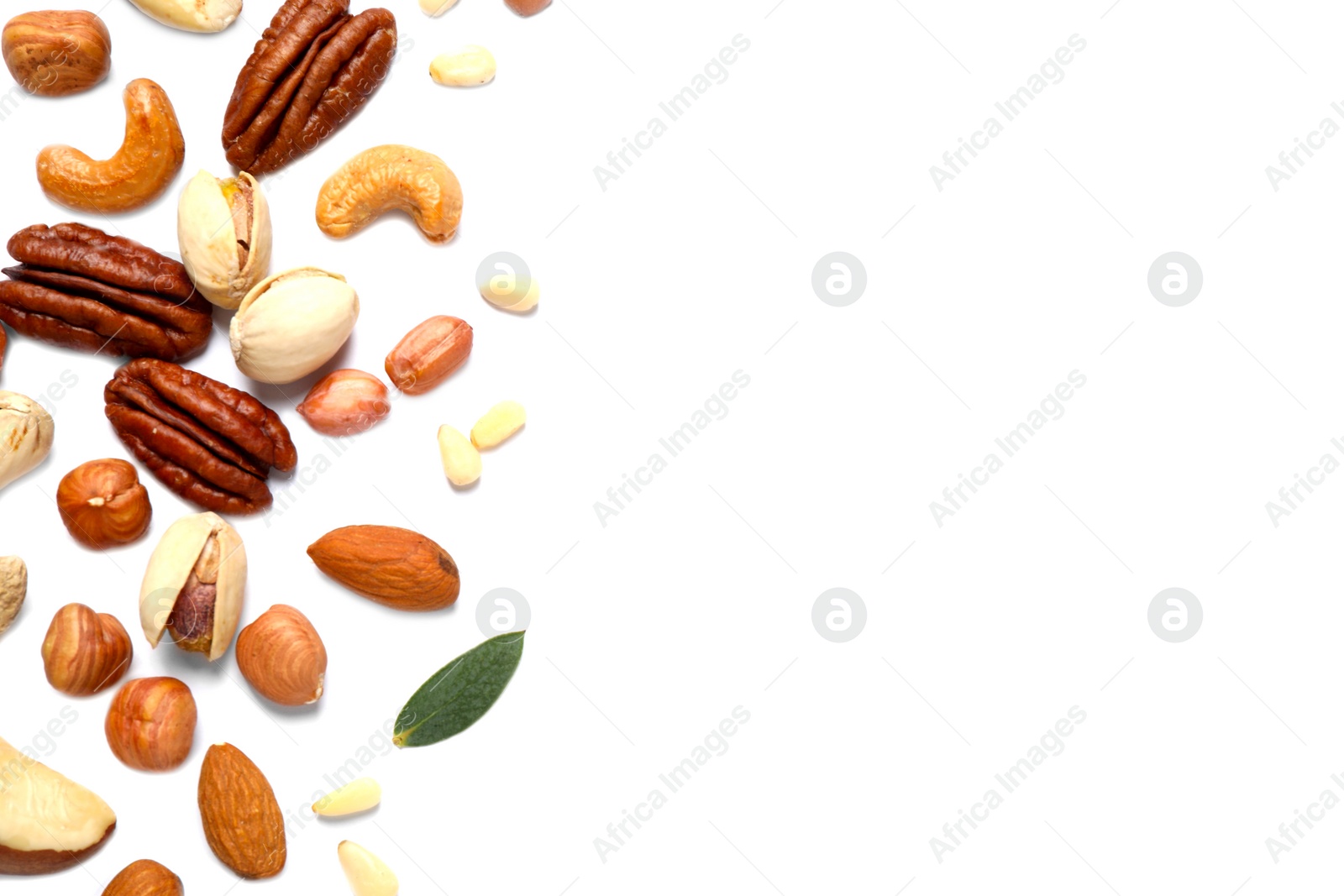 Photo of Different delicious nuts on white background, flat lay. Space for text