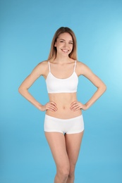 Young slim woman on color background. Perfect body