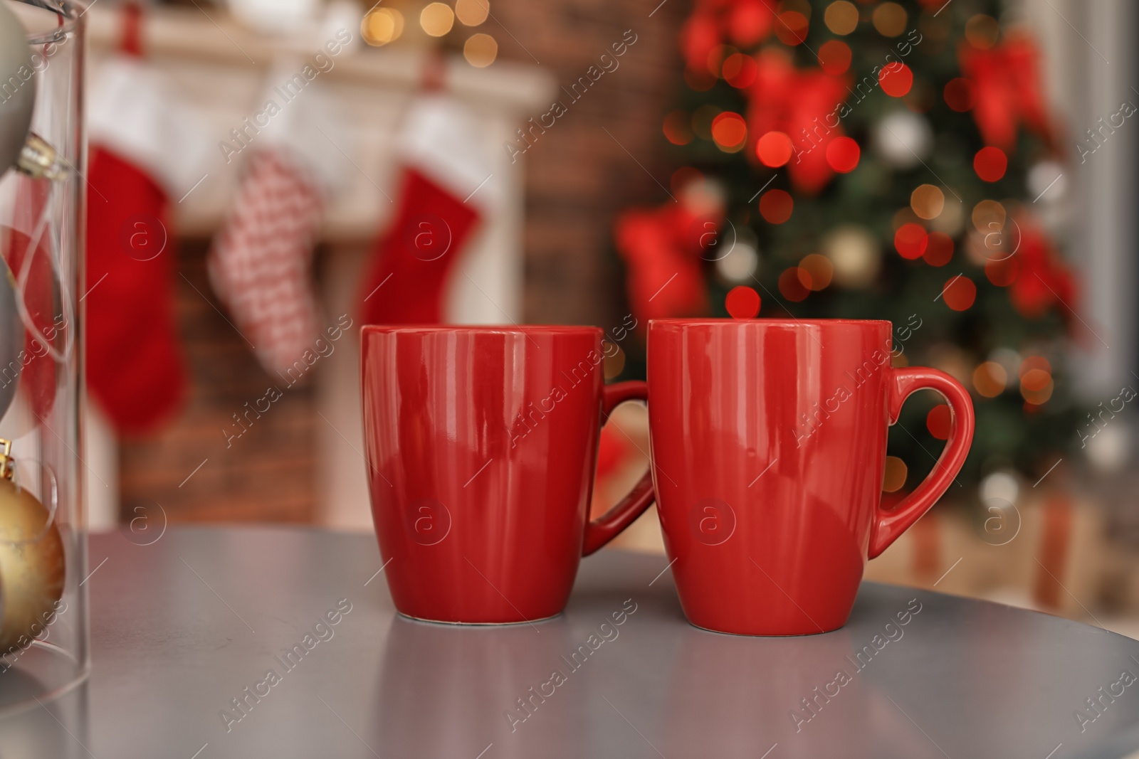 Photo of Red cups and Christmas tree in decorated room