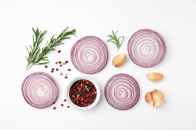 Fresh red onions, garlic, rosemary and spices on white background, flat lay