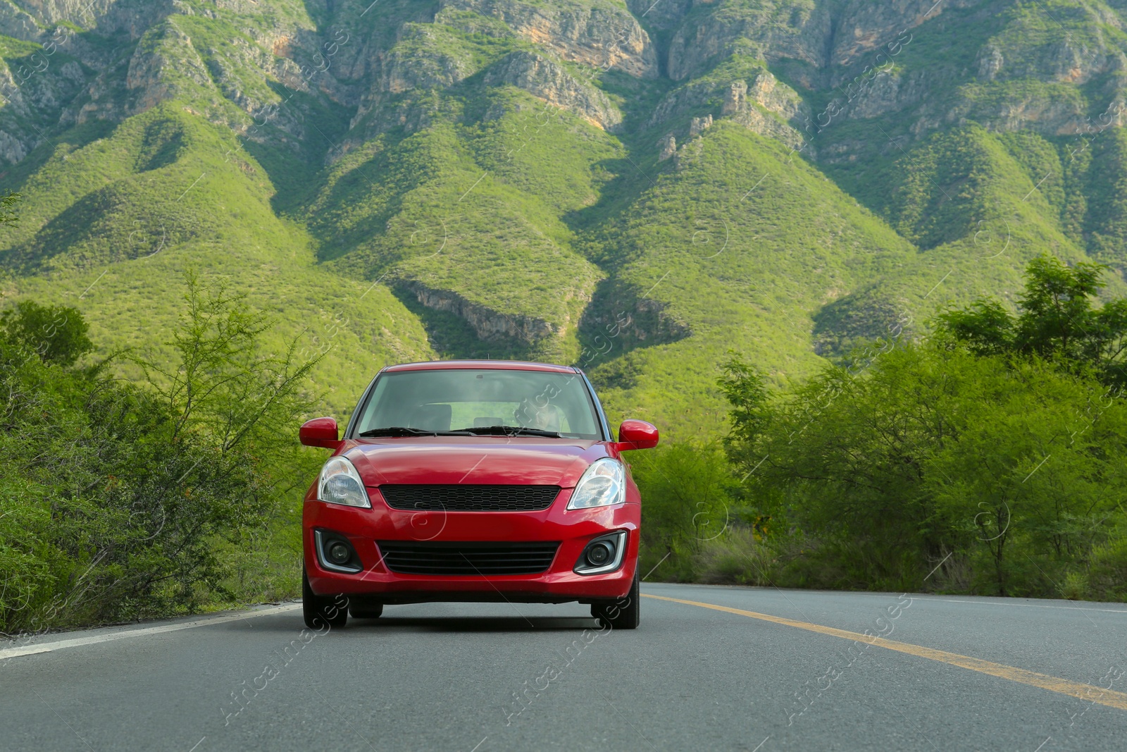 Photo of Beautiful view of car on asphalt highway in mountains. Road trip