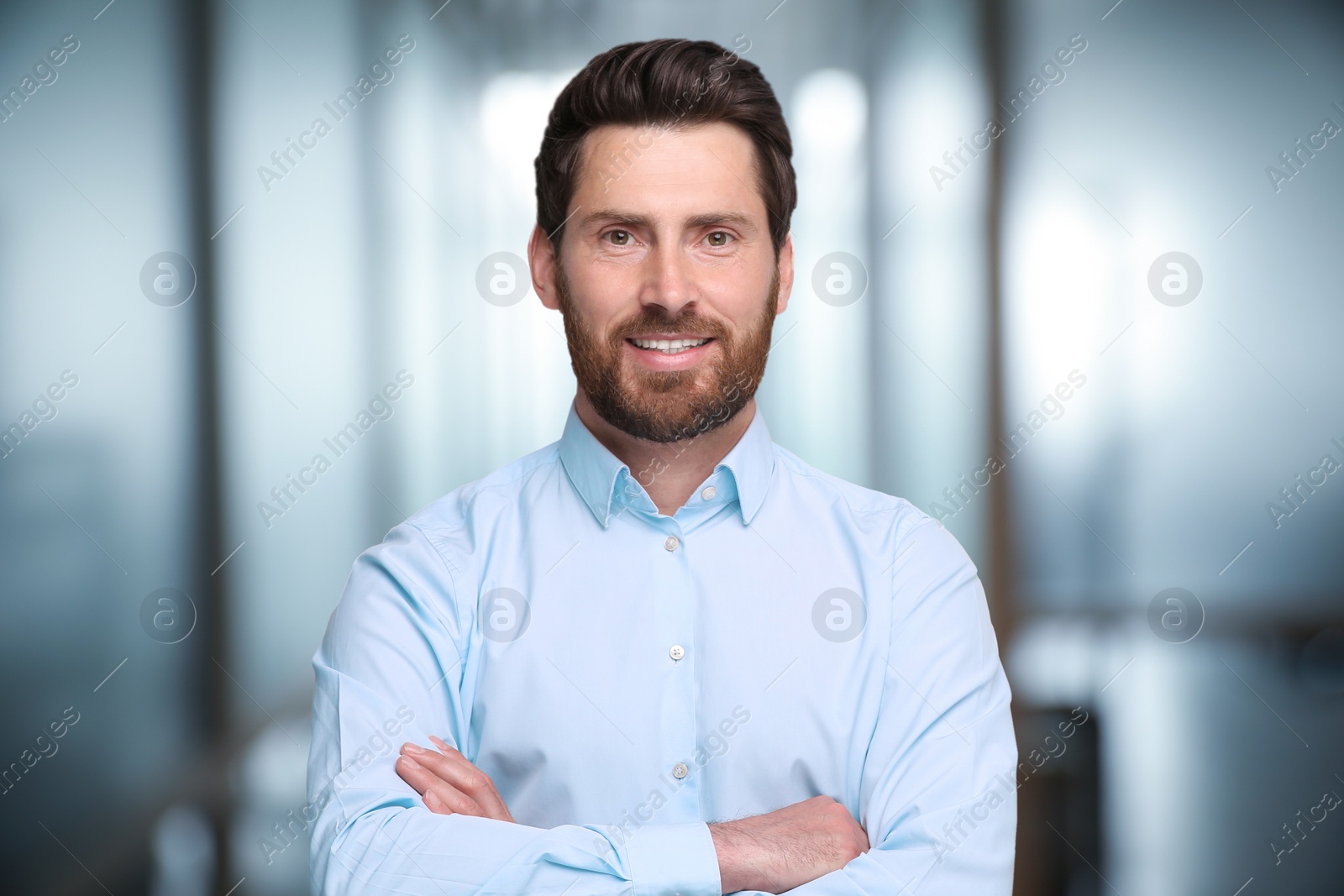 Image of Portrait of handsome confident man in office