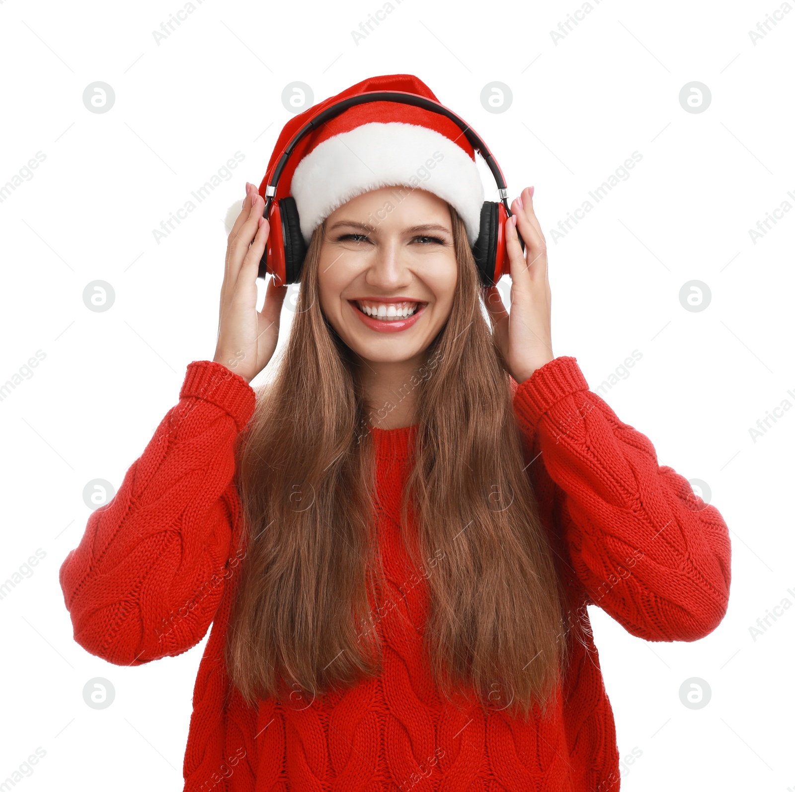 Photo of Young woman in Santa hat listening to Christmas music on white background