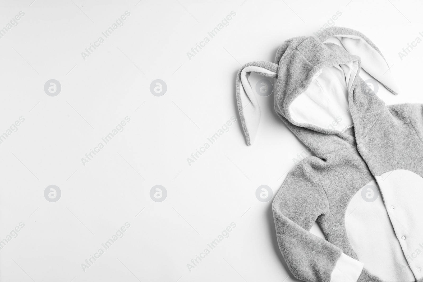 Photo of Adorable bodysuit with bunny ears and space for text on white background, flat lay. Baby accessories