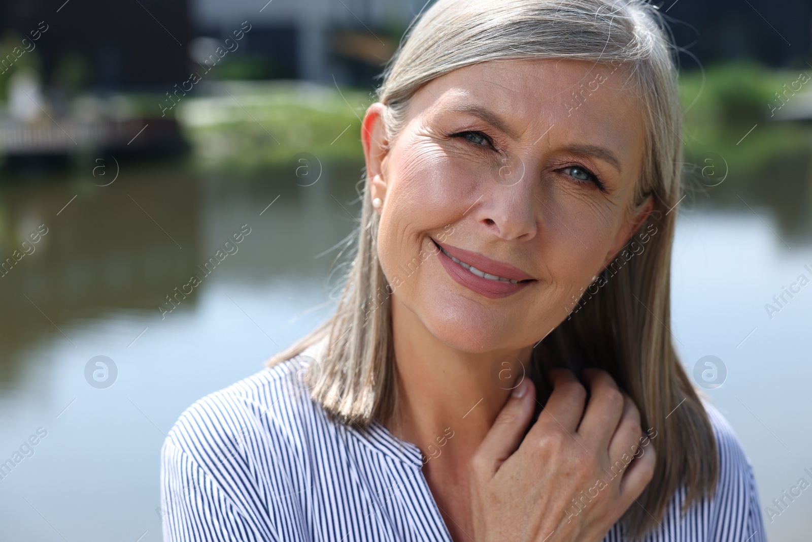 Photo of Portrait of beautiful happy senior woman outdoors