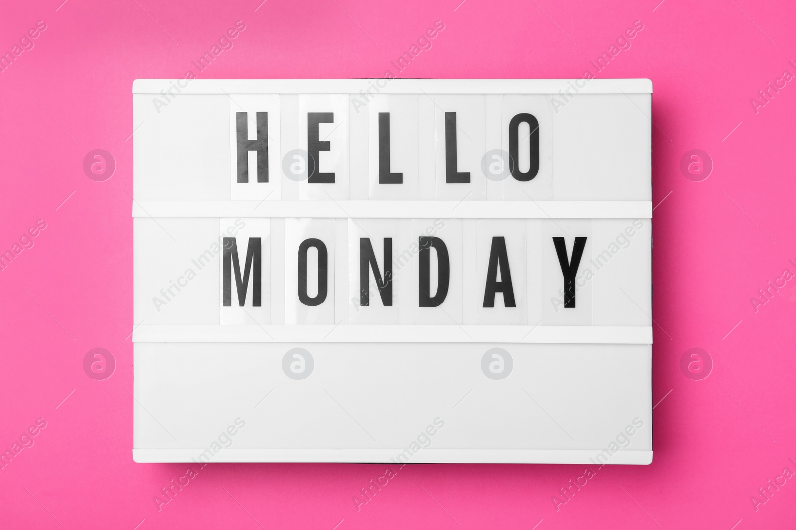 Photo of Light box with message Hello Monday on pink background, top view