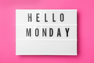 Photo of Light box with message Hello Monday on pink background, top view