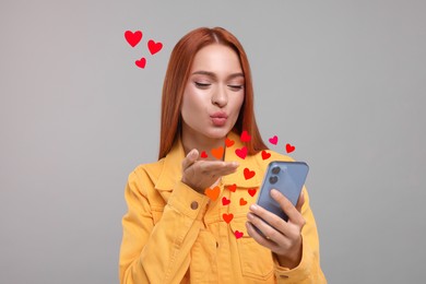 Image of Long distance love. Woman video chatting with sweetheart via smartphone on grey background. Hearts flying out of device