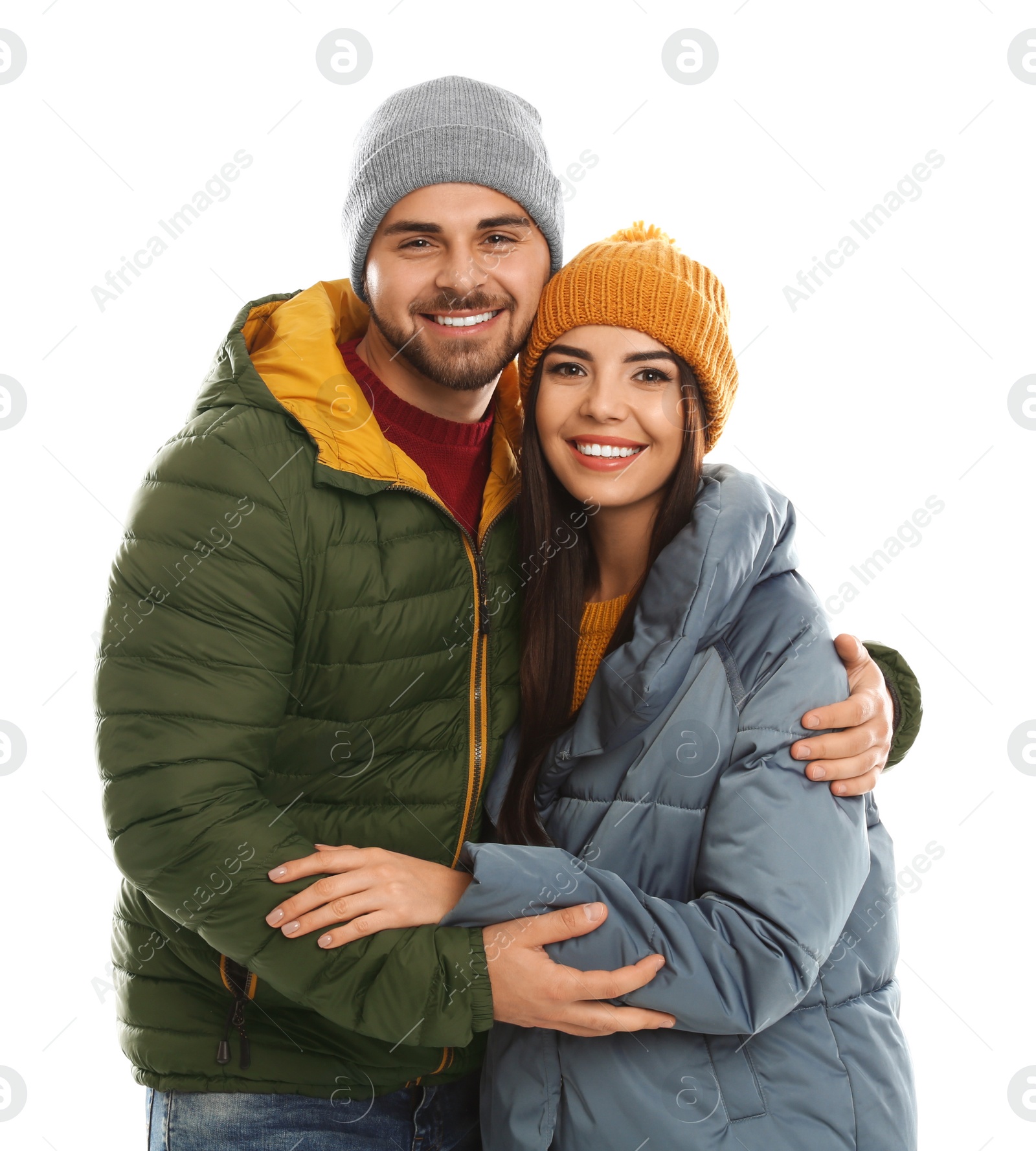 Photo of Happy young couple in warm clothes on white background. Winter vacation